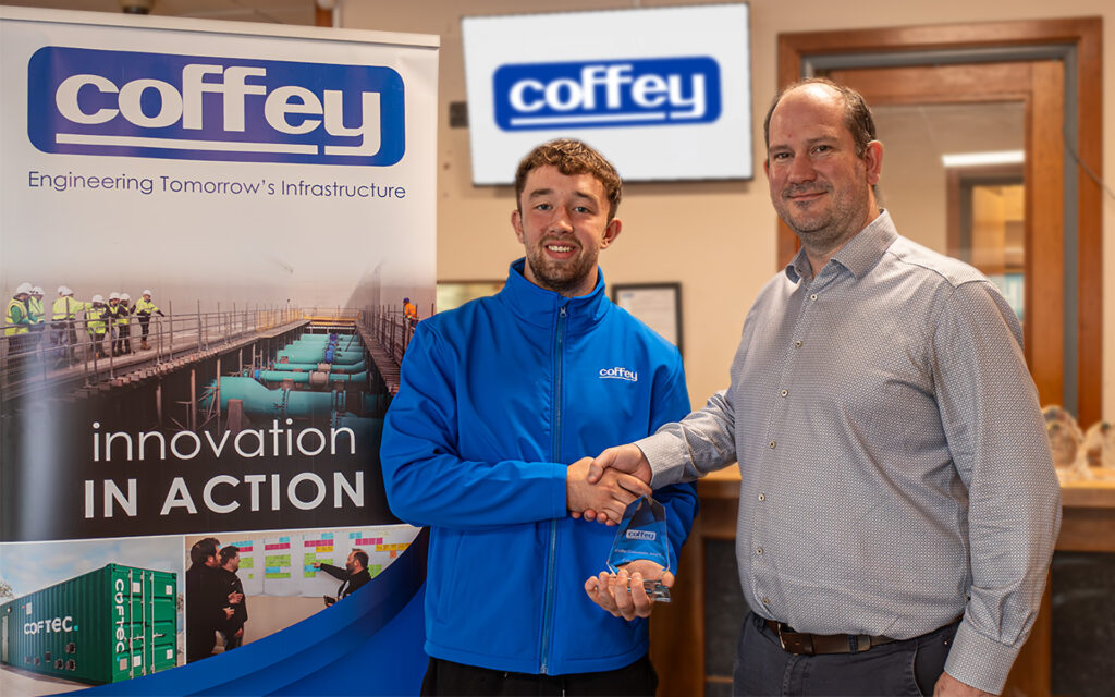 Cathal Campbell Accepting the Coffey Excellence Award for Community Impact from Chief financial Officer Stuart Smith